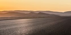 Empty,Asphalt,Road,And,Mountain,Scenery,At,Sunrise